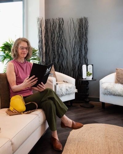 New guest relaxing in the Murraki Salon waiting area before a personalized hair appointment in downtown Boise.